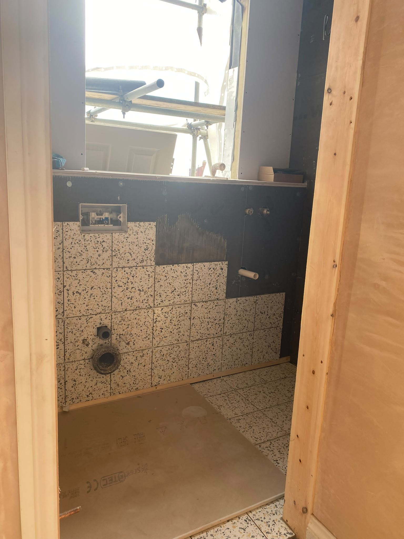 En-suite bathroom during tiling