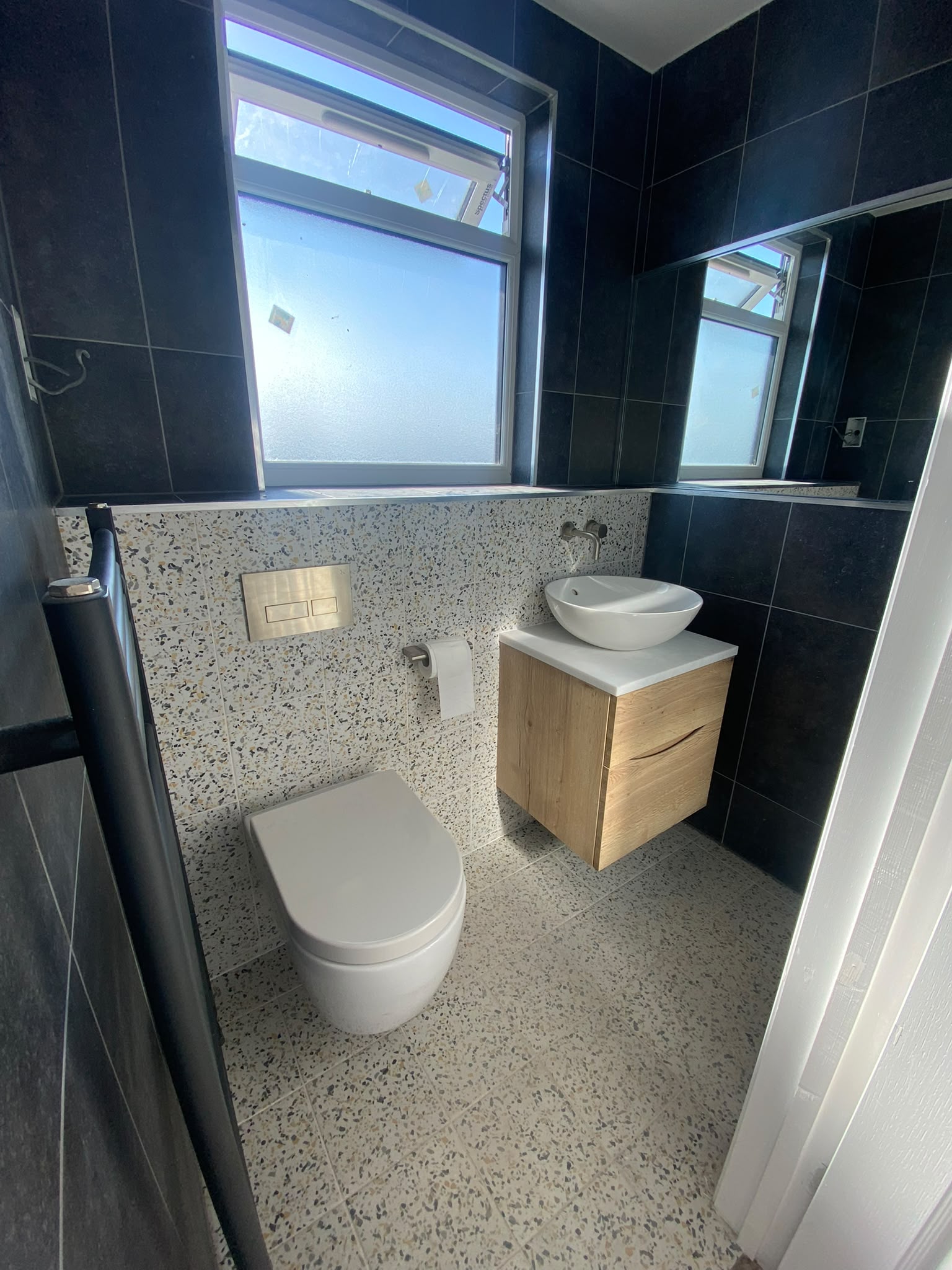Completed navy and terrazzo en-suite bathroom