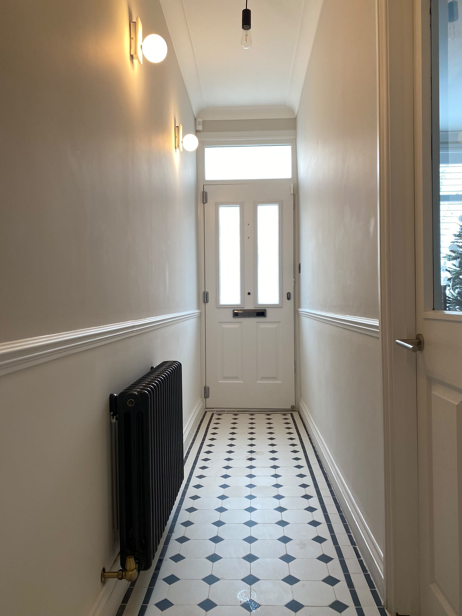 Completed entrance hallway with patterned tiled floor